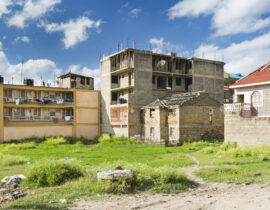 A ruin next to a building under construction, a typical view in the village of Tassia in east Nairobi, Kenya.